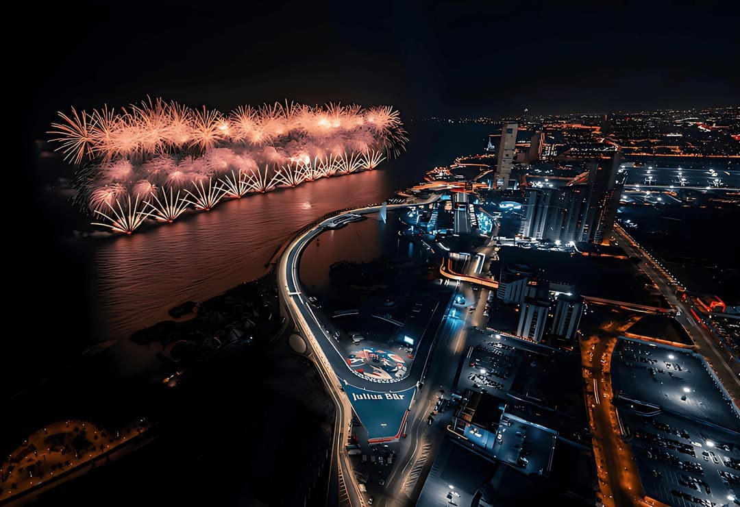 Aerial night view of a waterfront with fireworks and marine platforms